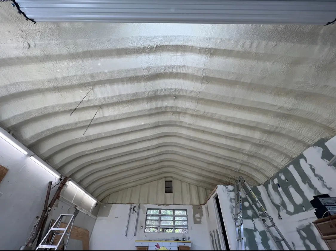 Spray polyurethane foam applied to the underside of a metal roof deck in Williamsburg